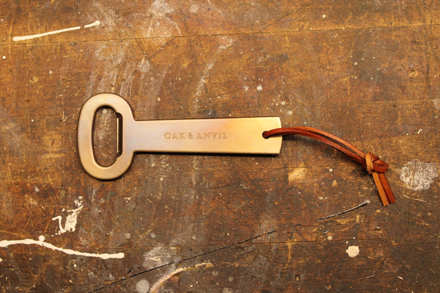 Metal bottle opener on wood bench 