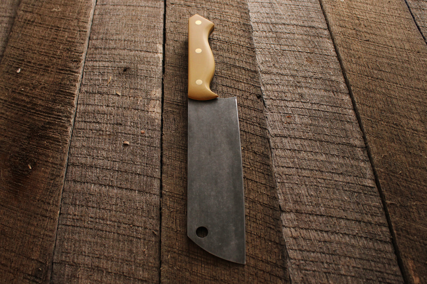 Chefs knife with stone washed blade and antique ivory micarta handle on wood