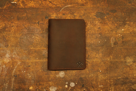 Leather notebook holder closed on old work bench