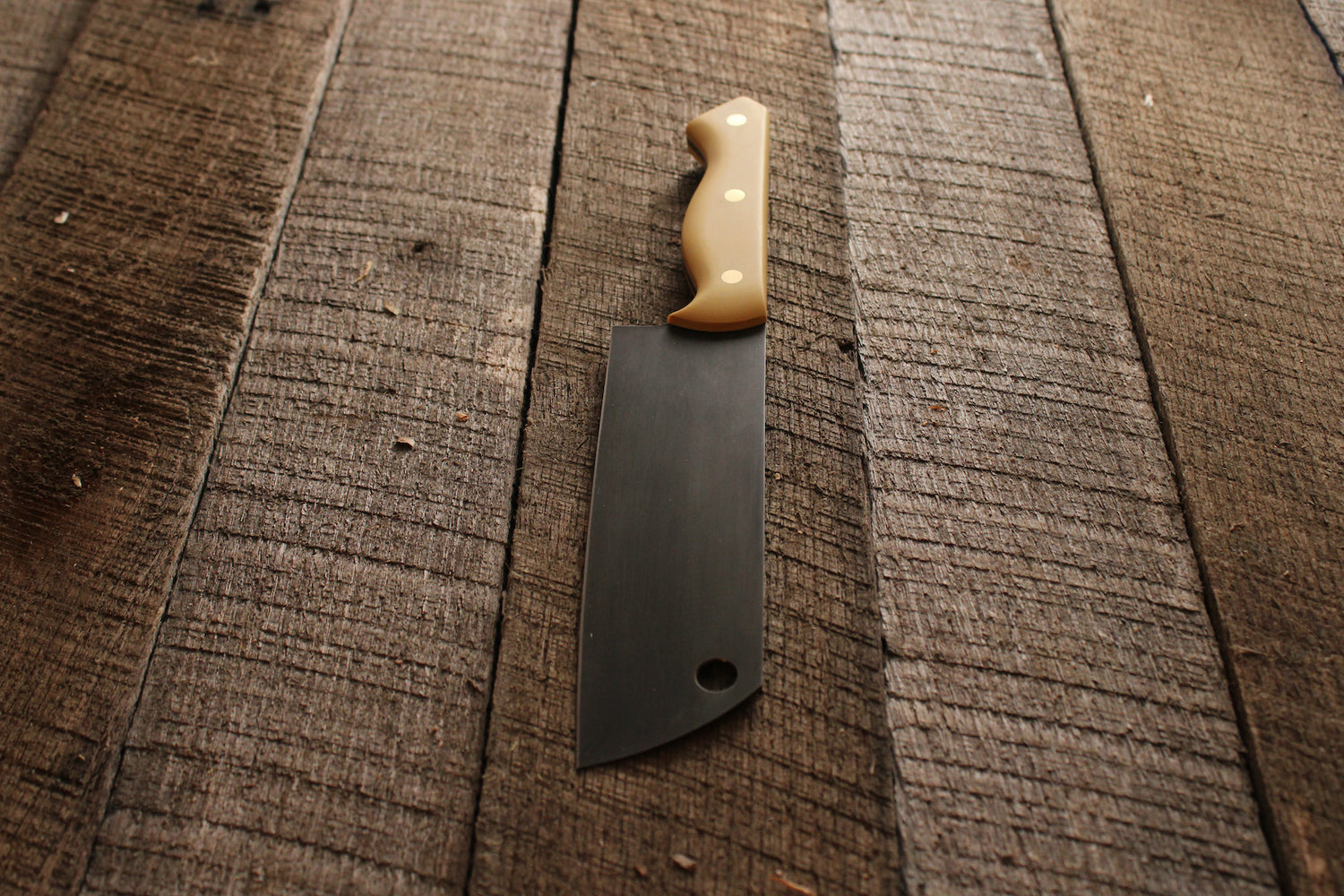 Chefs knife with acid etched blade and antique ivory micarta handle on wood