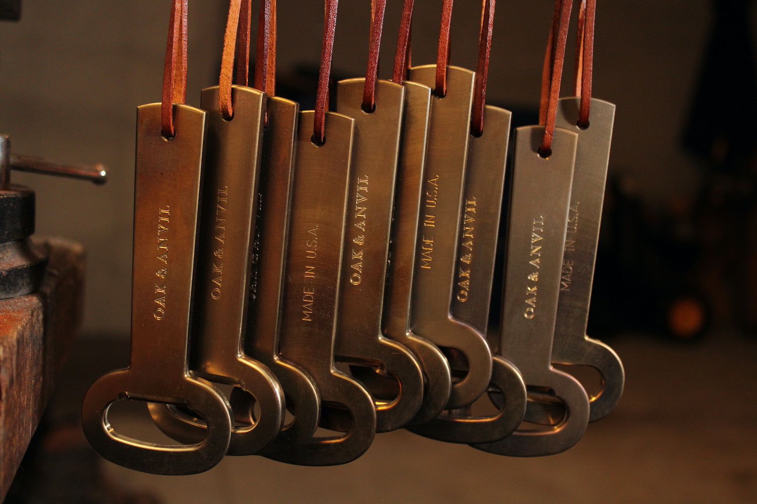 Oak and Anvil bottle openers hanging by leather lanyards